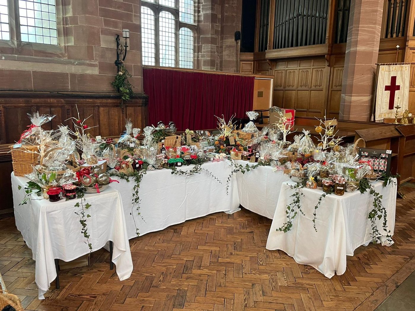 Christmas Stall hampers and decorations laid out in the church